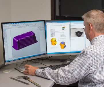 Form Plastics employee using CAD program to design a meal tray
