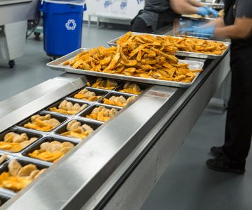 Workers preparing packaged meals